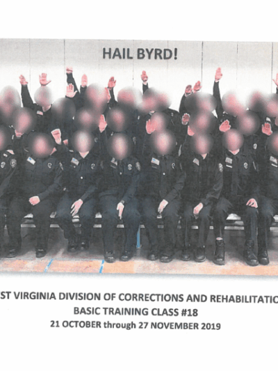 Image shows Class No. 18 with faces blurred raising hands in a Nazi-style salute