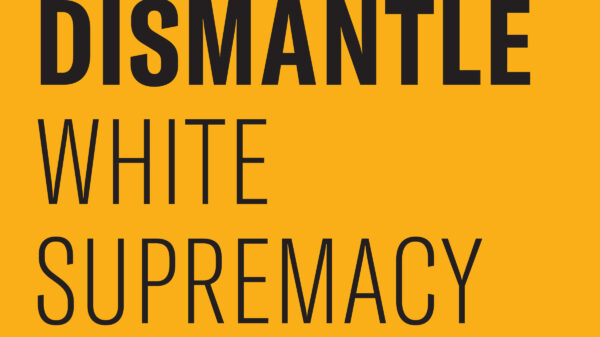 Black text on a gold background says "Dismantle White Supremacy."