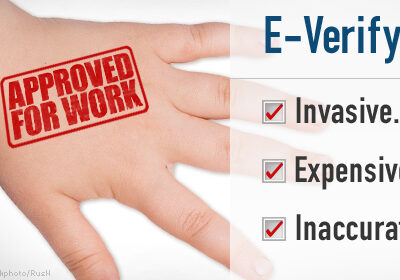 Image shows a red stamp on a person's hand reading "APPROVED FOR WORK." A sidebar describes E-Verify as Invasive, Expensive, and Innacurate