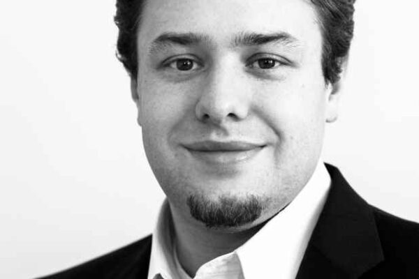 Black and white portrait of ACLU-WV Policy Director Eli Baumwell