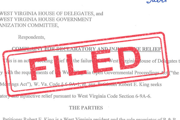 "Filed" stamped in red over an image of a lawsuit