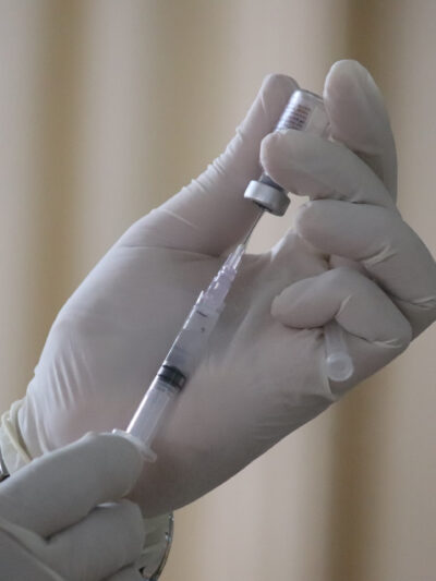 COVID-19 vaccine is drawn into a syringe
