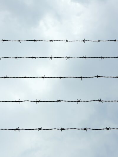 A photo of prison wire against a sky