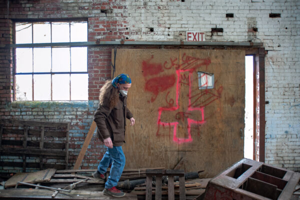 Dominique Miller searches an abandoned building for people using it as shelter.