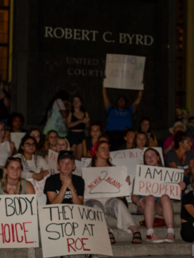 Abortion rights protesters hold signs with messages like "My Body, My Choice" in front of the federal courthouse in Charleston, West Virginia