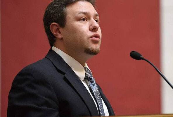 Eli Baumwell speaks into a microphone during a public hearing at the West Virginia Legislature