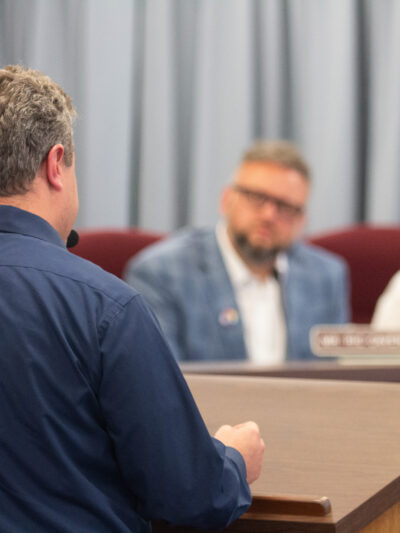 Photo shows Eli Baumwell from behind as he addresses members of the Kanawha County Board of Education