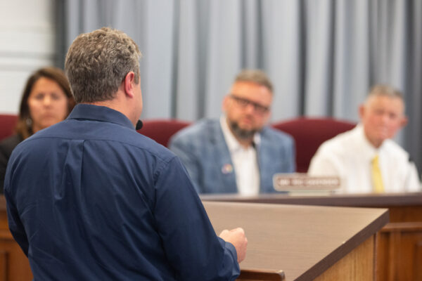 Photo shows Eli Baumwell from behind as he addresses members of the Kanawha County Board of Education