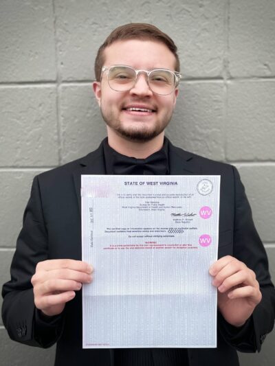 Xavier Hersom holds a picture of his birth certificate