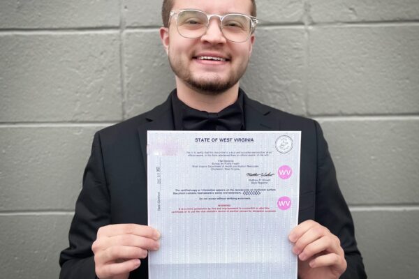 Xavier Hersom holds a picture of his birth certificate