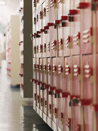 A photo of red lockers in a school hallway