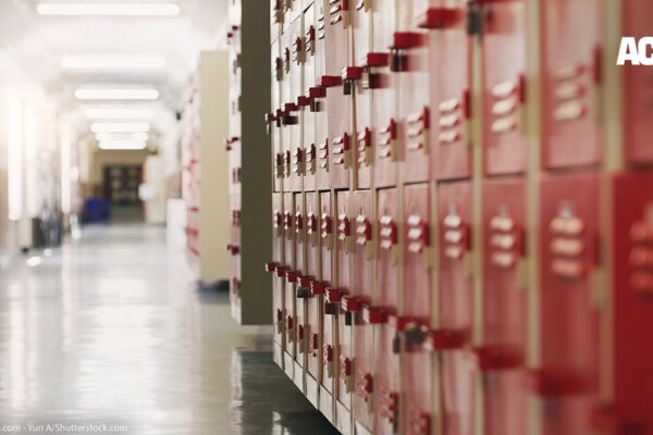 A photo of red lockers in a school hallway