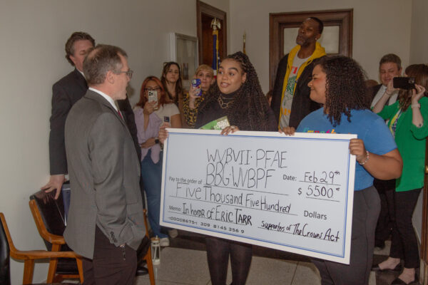 ACLU-WV advocates present a check to Senator Eric Tarr