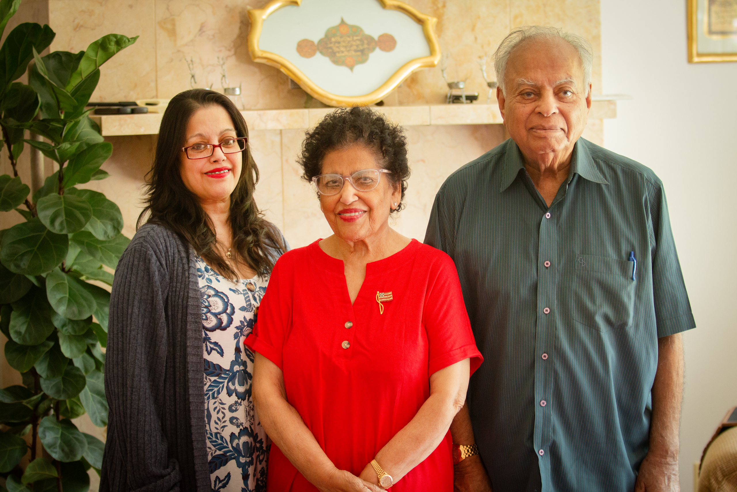 Farrah Zahir and her parents Amnda and Dr. Syed Zahir in the living room of her parents' home in Beckley.