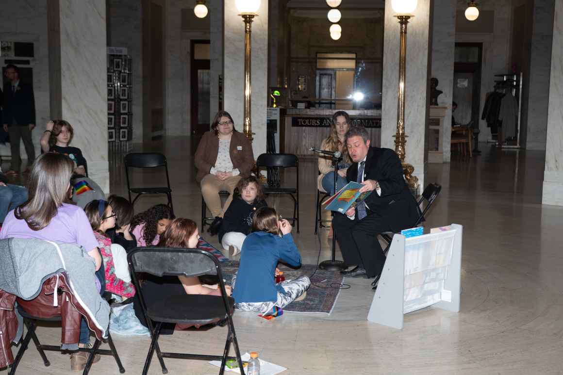 Executive Director Eli Baumwell reads to kids in the Capitol Rotunda.