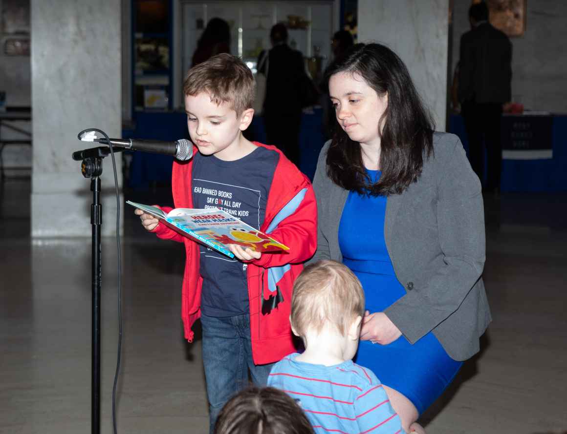 A young supporter reads a Sesame Street book that West Virginia lawmakers have considered banning