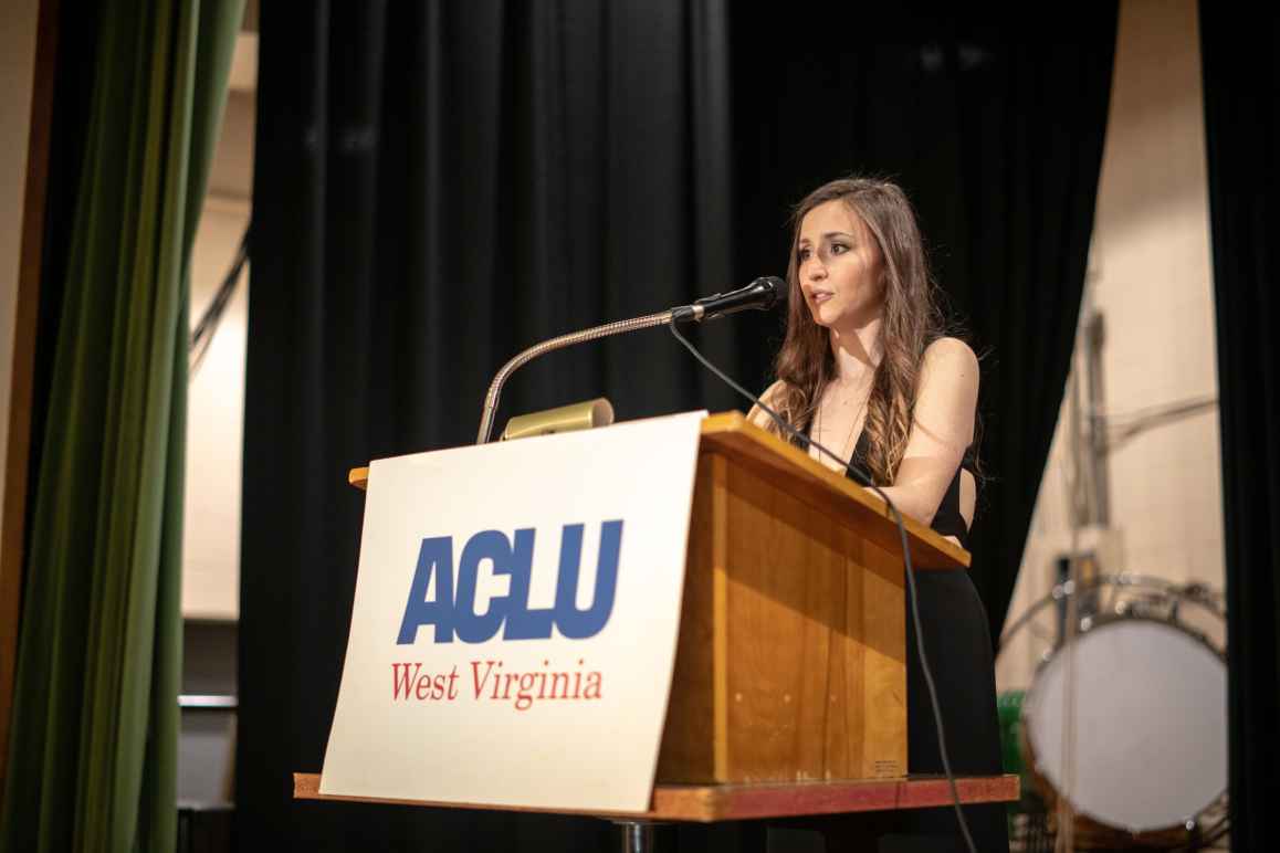 Mollie Kennedy speaks at an ACLU-WV podium