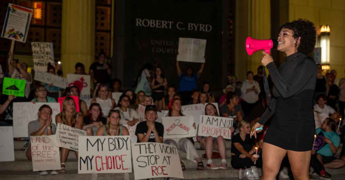 Abortion rights protesters hold signs with messages like "My Body, My Choice" in front of the federal courthouse in Charleston, West Virginia