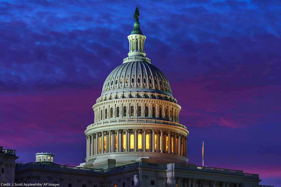 The United States Capitol building is shown at night. 