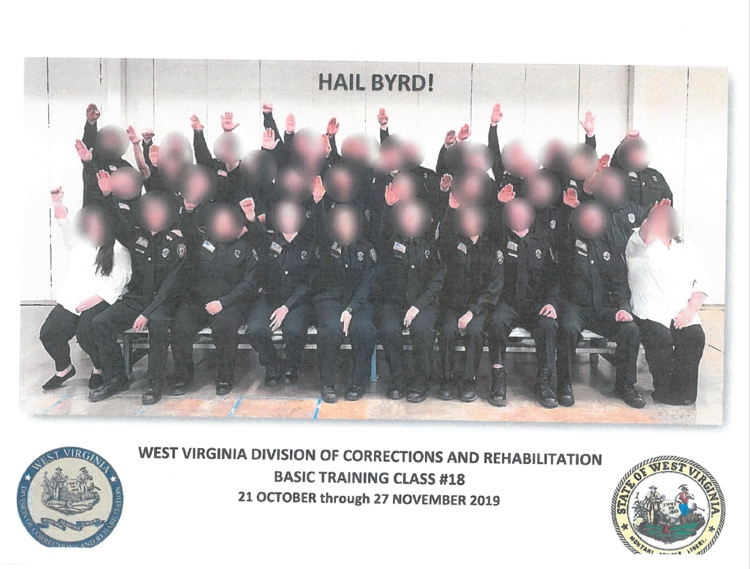 Photo shows a class of WV Corrections cadets, arms raised in a Nazi salute. Faces are blurred.