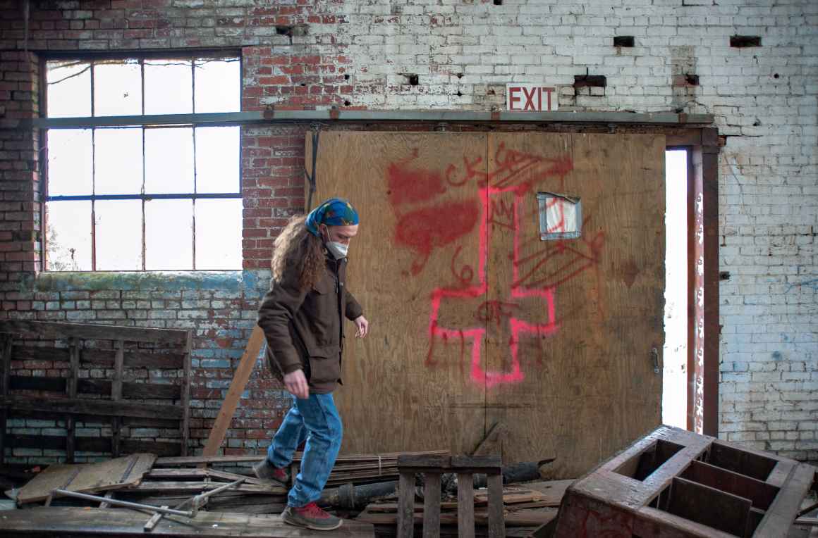 Dominique Miller searches an abandoned building for people using it as shelter. 