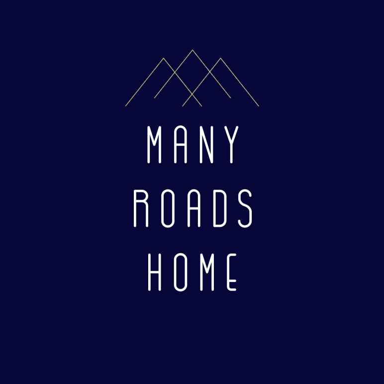 Image features a mountain scape with the words "Many Roads Home"