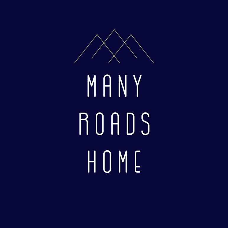 Image features a mountain scape with the words "Many Roads Home"