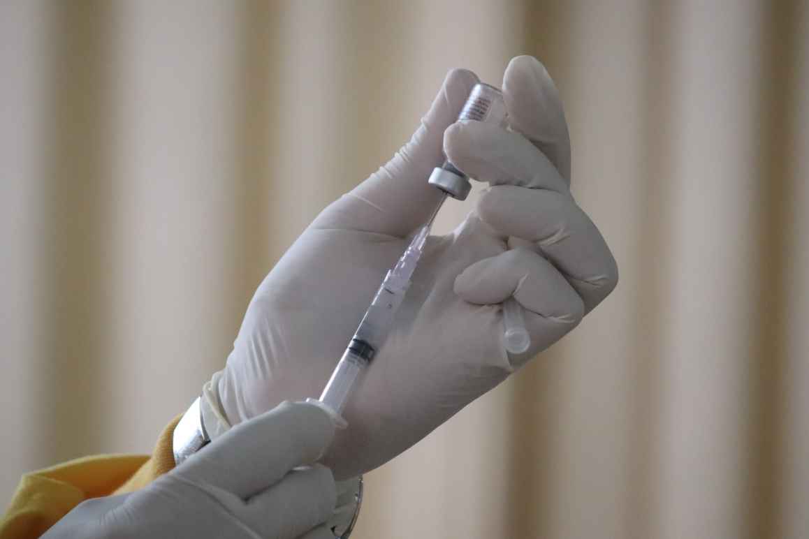 COVID-19 vaccine is drawn into a syringe