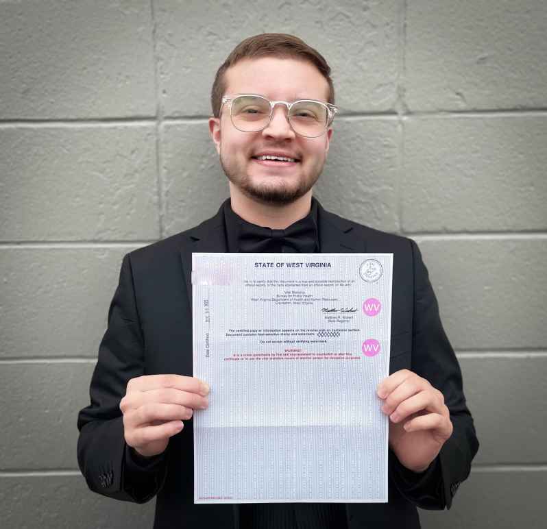 Xavier Hersom holds a picture of his birth certificate