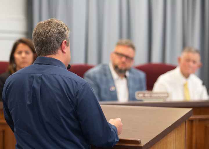 Photo shows Eli Baumwell from behind as he addresses members of the Kanawha County Board of Education