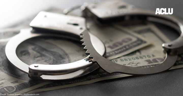 Handcuffs are shown with 100 dollar bills to symbolize the cash bail system