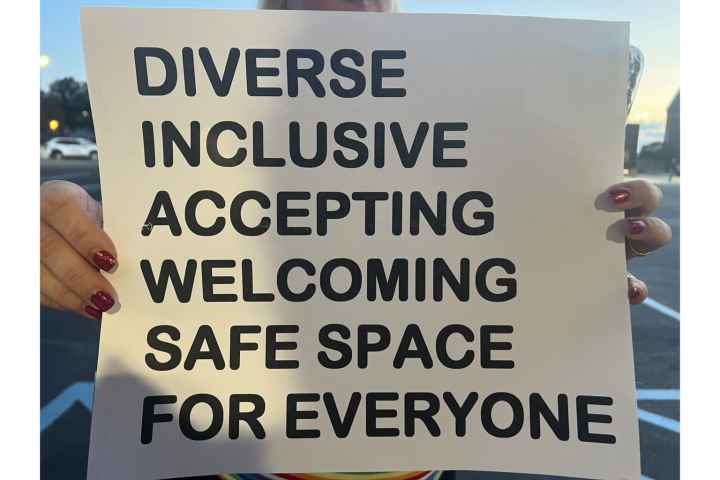 A sign reads "DIVERSE INCLUSIVE WELCOMING SAFE SPACE FOR EVERYONE"