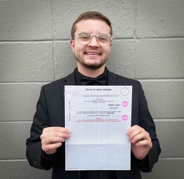 Xavier Hersom holds a picture of his birth certificate