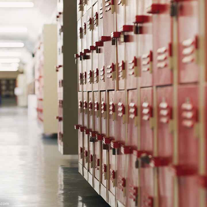 A photo of red lockers in a school hallway