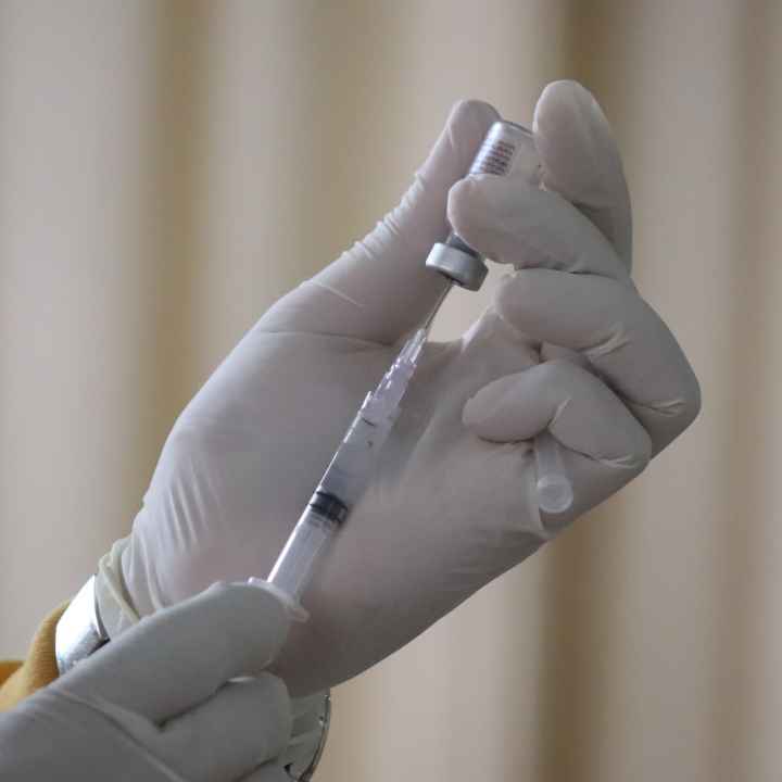 COVID-19 vaccine is drawn into a syringe